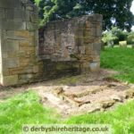 Part of the window frame from the North wall is lying on the ground in front of the wall. It held a stained glass window Heath Old Church